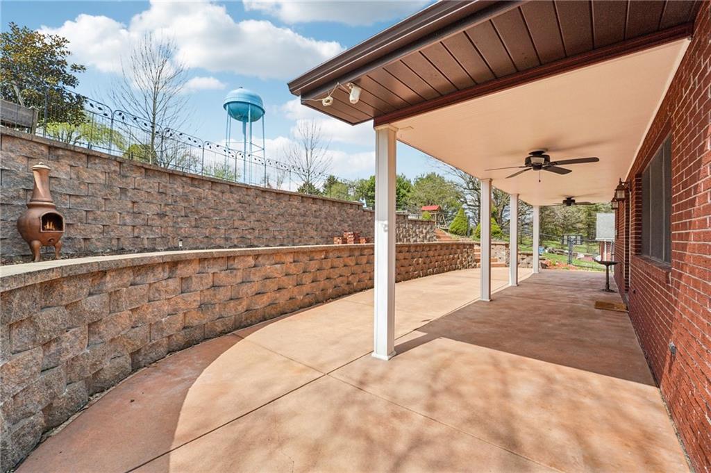 644 Grange Drive Apollo, PA 15613 - Photo 38 of 46 Stained cement patio are that is covered for beautiful entertaining. Notice fan and Keystone block retaining wall along with columned bead board porch overhang another coveted area