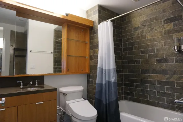 a bathroom with a toilet a sink and bathtub