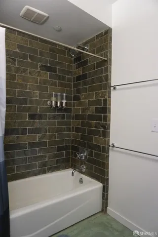 a bathroom with a bathtub and a shower