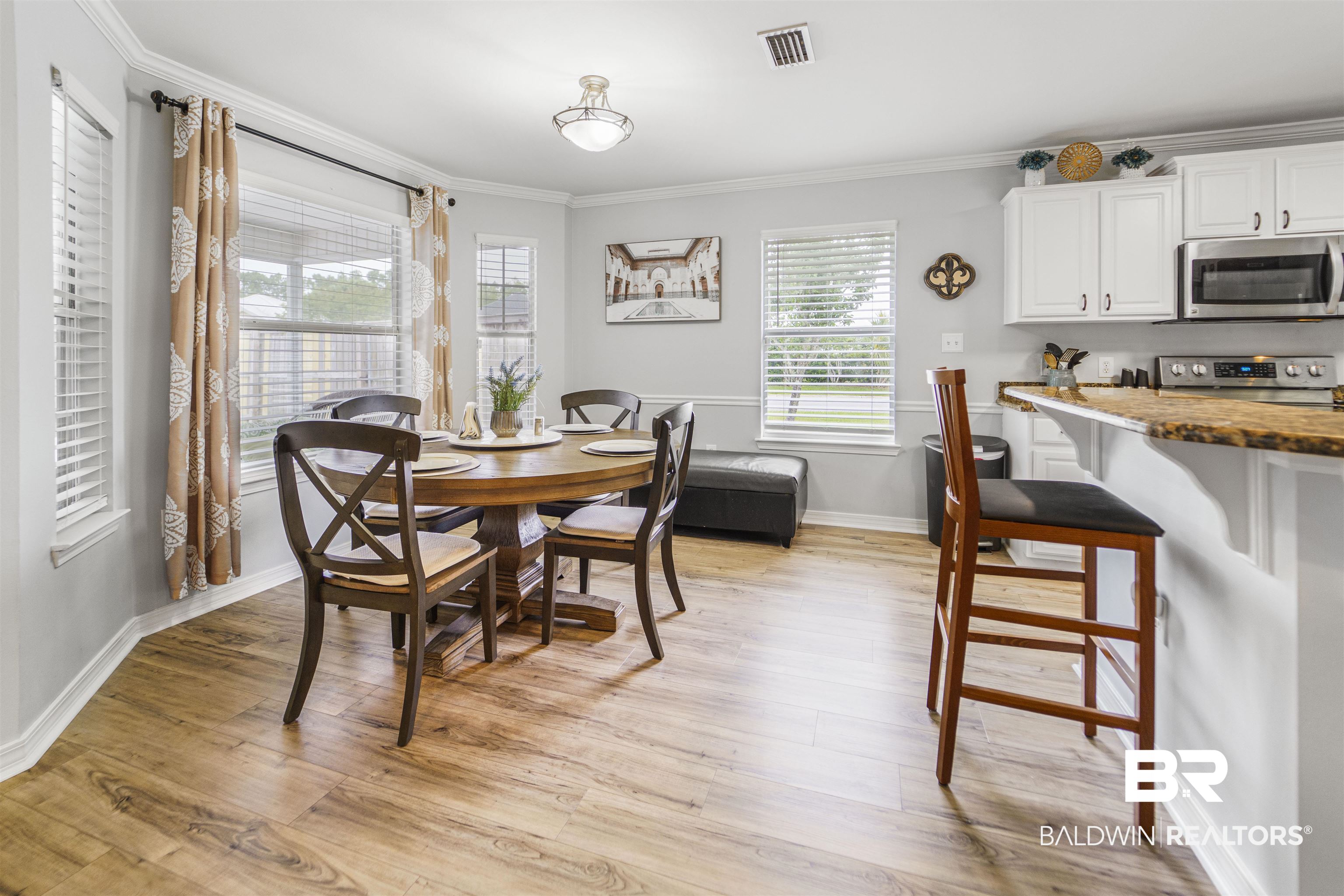 4620 Pine Boulevard Orange Beach, AL 36561 - Photo 8 of 49 Dining area with plenty of natural light, light wood finished floors, and crown molding