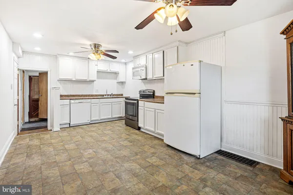 a kitchen with cabinets and stainless steel appliances
