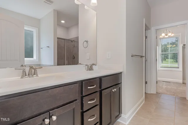 a bathroom with a sink double vanity and a mirror