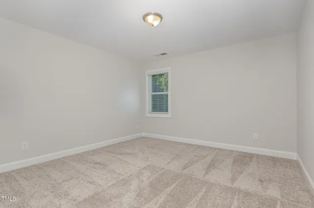 an empty room with a empty space and window