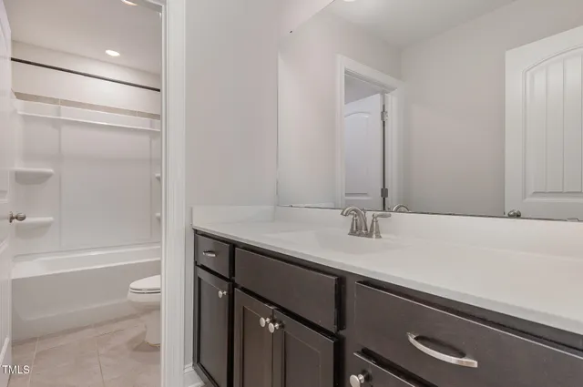 a bathroom with a sink a toilet and a bathtub