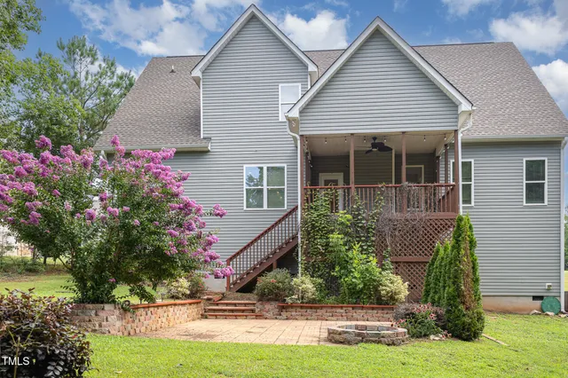 a house that has a big yard and large trees