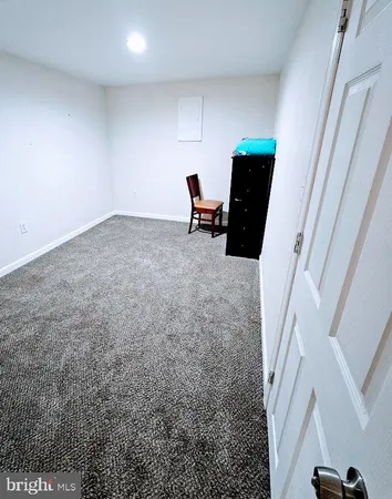 a large bed sitting in a bedroom next to a window