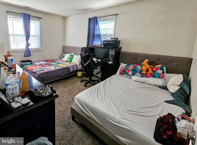 a bedroom with bed and window