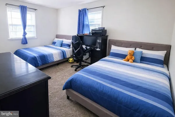 a bedroom with bed and window