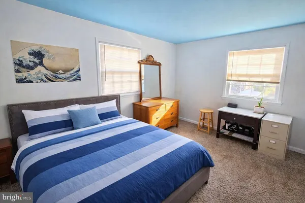 a bedroom with baby bed and a window