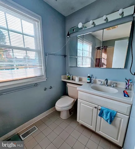 a bathroom with a sink toilet and window