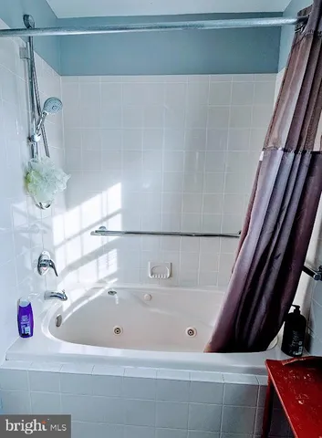 a bathroom with a bathtub and shower