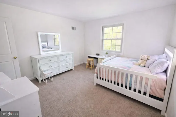 a bathroom with a sink toilet and window