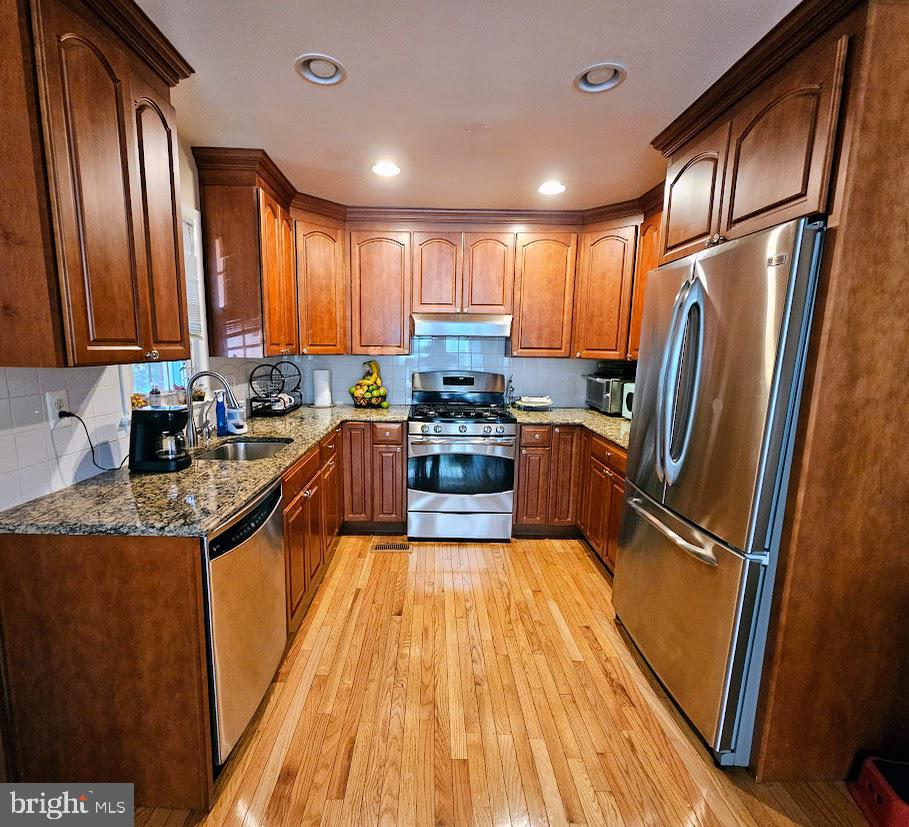 13316 Foxhall Drive Silver Spring, MD 20906 - Photo 6 of 32 a kitchen with stainless steel appliances granite countertop a refrigerator a sink dishwasher a stove and a dining table with wooden floor