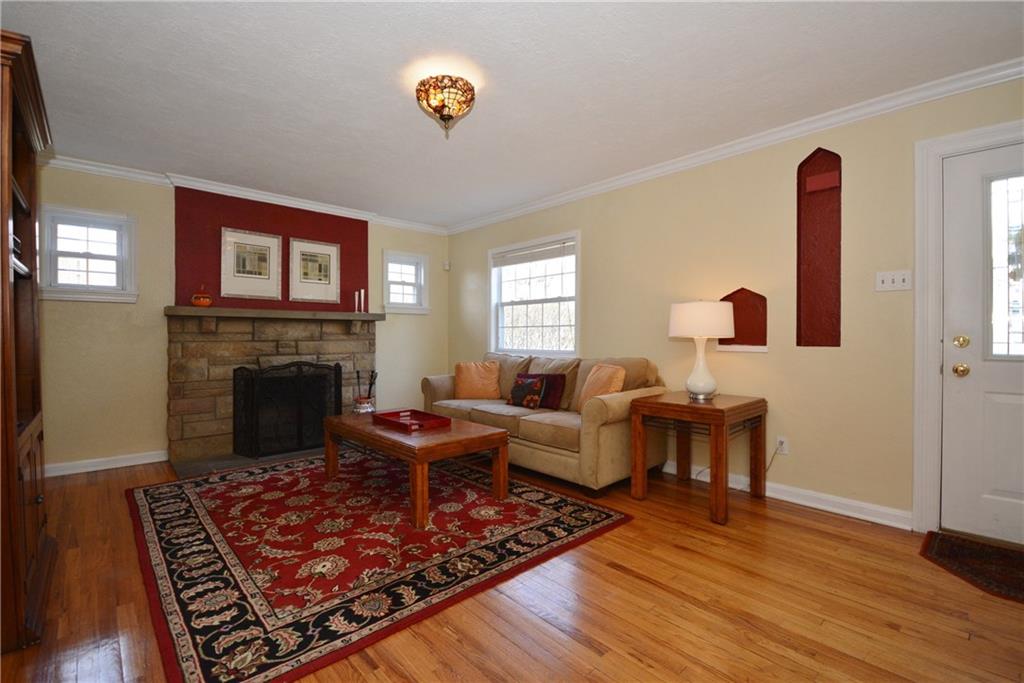 2017 Mohawk Road Pittsburgh, PA 15241 - Photo 4 of 23 Lovely living room with stone fireplace in the front of the home. Notice the abundance of light shining through the windows.