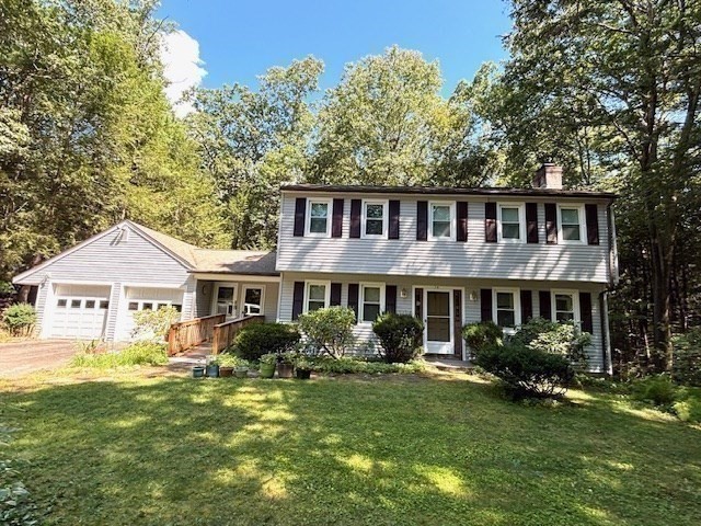 14 Pebble Ridge Road Amherst, MA 01002 - Photo 1 of 32 a front view of a house with garden and trees