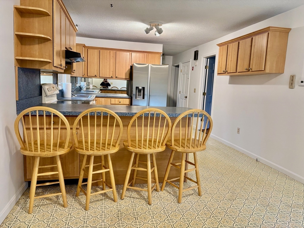 14 Pebble Ridge Road Amherst, MA 01002 - Photo 22 of 32 a table with chairs and cabinets