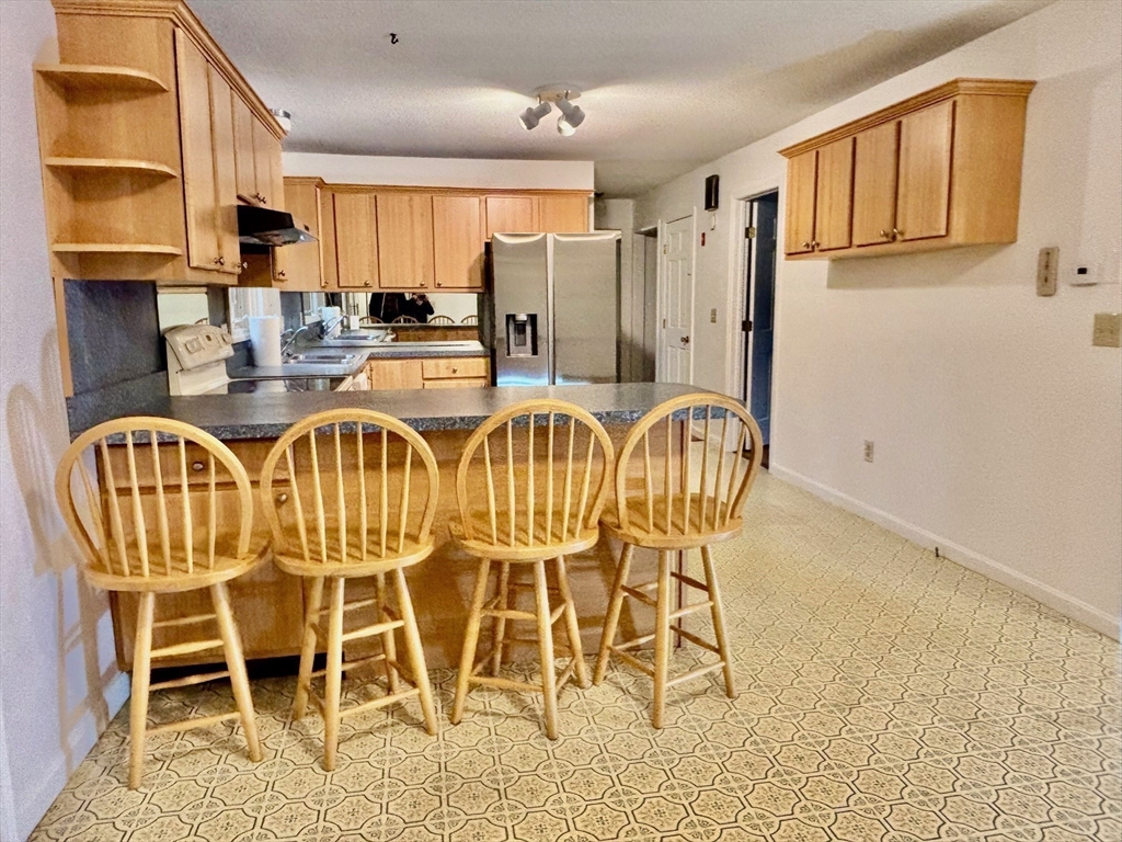 14 Pebble Ridge Road Amherst, MA 01002 - Photo 24 of 32 a dining room with furniture a window and kitchen view