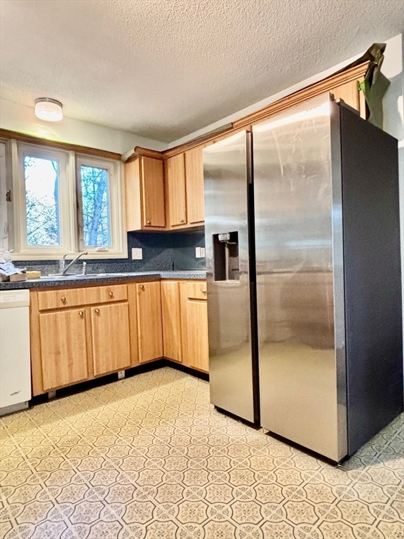 14 Pebble Ridge Road Amherst, MA 01002 - Photo 25 of 32 a kitchen with granite countertop a refrigerator a sink and cabinets