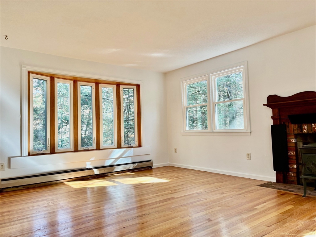 14 Pebble Ridge Road Amherst, MA 01002 - Photo 3 of 32 a view of an empty room with wooden floor and a window