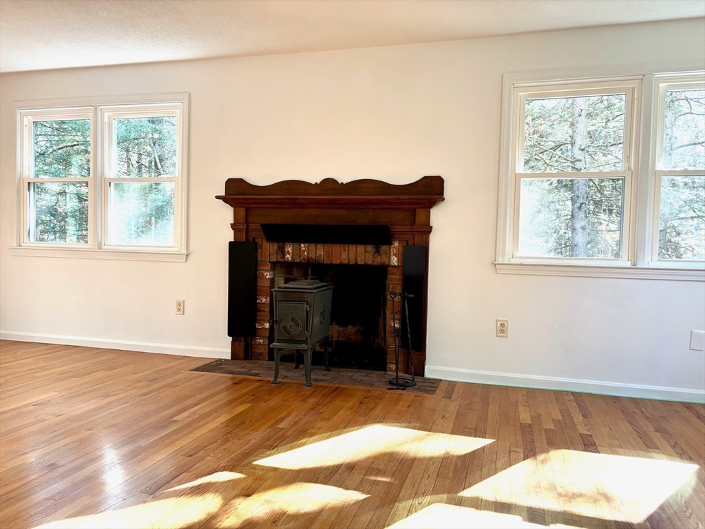 14 Pebble Ridge Road Amherst, MA 01002 - Photo 5 of 32 a view of an empty room with a fireplace and a window
