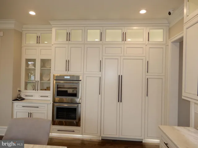 a kitchen with stainless steel appliances a refrigerator and a stove top oven