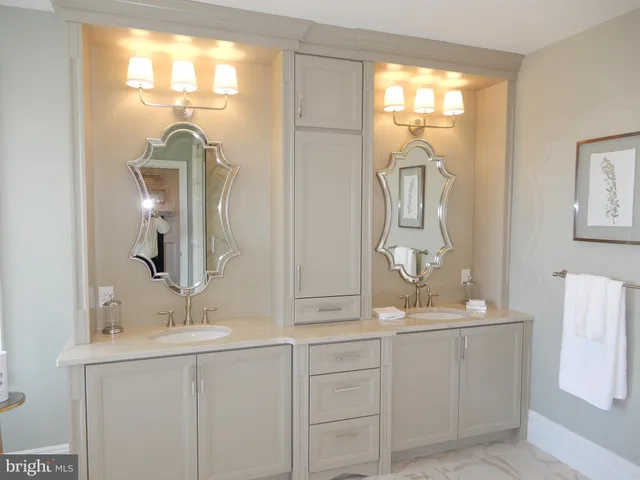 a bathroom with a double vanity sink mirror and double
