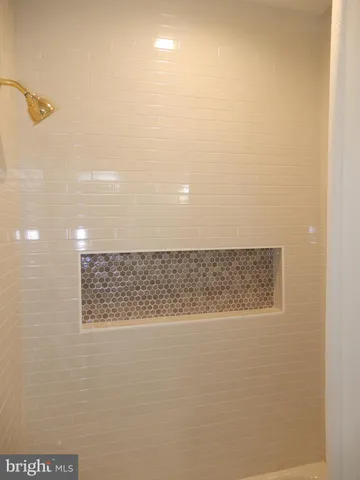 a kitchen with stainless steel appliances granite countertop a kitchen island a stove and a refrigerator