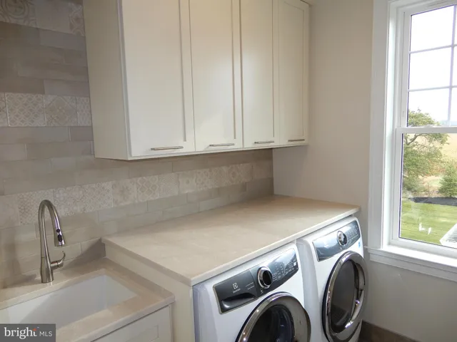 a kitchen with a dining table chairs and wooden floor