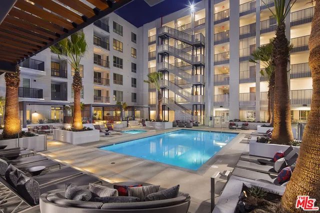 a view of a swimming pool with outdoor seating