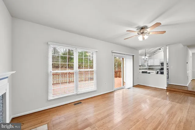 a view of an empty room with a kitchen