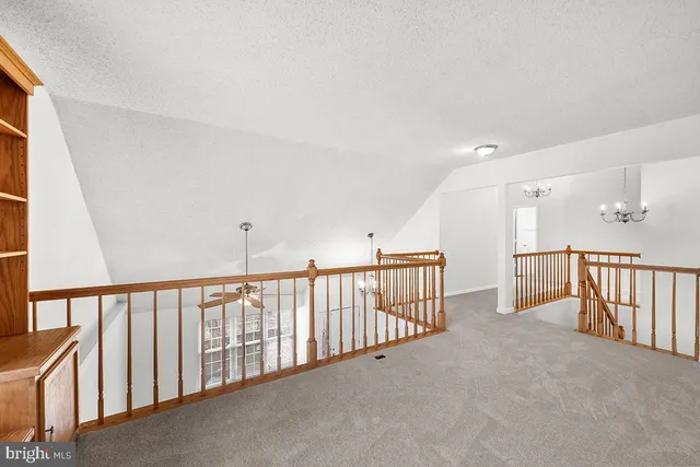 a view of a hallway with staircase