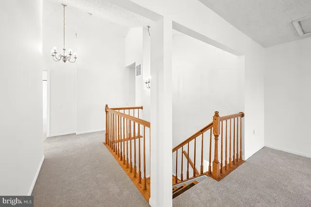 a view of a hallway with wooden floor and entryway