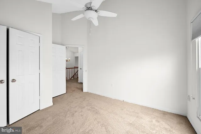 a view of a big room with closet and chandelier fan