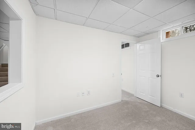 a view of a house with a barbeque and wooden stairs
