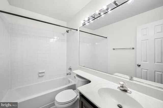 a view of a field with trees in the background