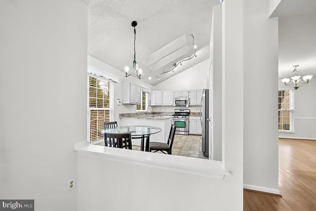 a view of a kitchen and an empty room