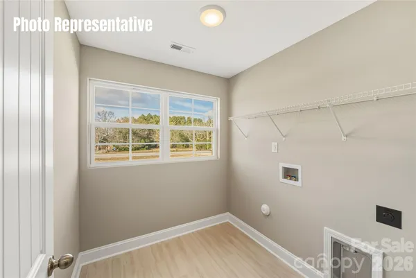 a view of a room with a window and a ceiling fan