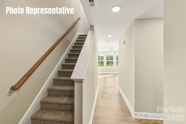 a view of entryway and hall with wooden floor