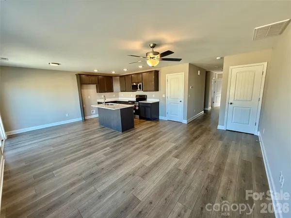 a view of living room and kitchen with wooden floor