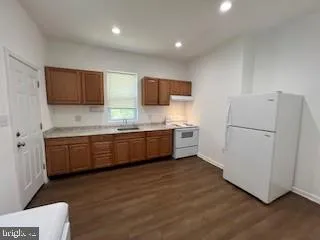 a kitchen with stainless steel appliances a refrigerator sink and microwave