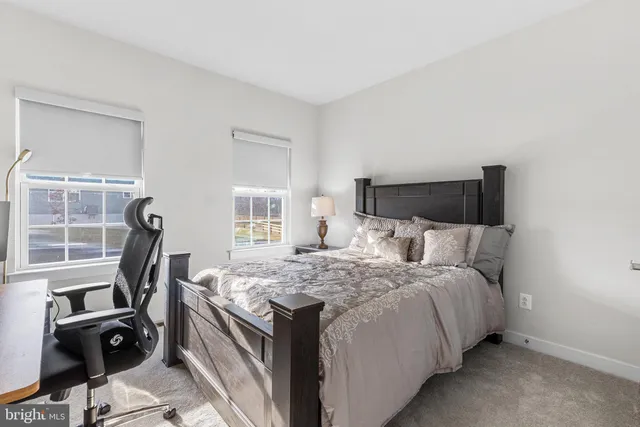 a bedroom with a bed and a night stand