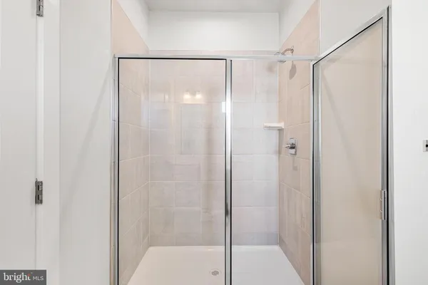 a en suite bathroom with double sink a mirror and a shower