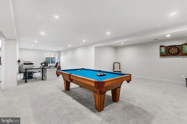 a living room with furniture and a gym machine