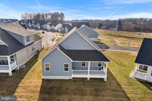 a aerial view of a house next to a yard