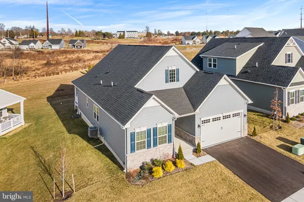 an aerial view of a house with a yard