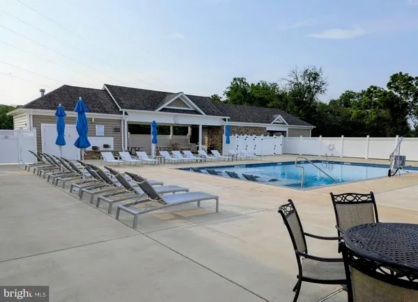 a swimming pool with outdoor seating and yard