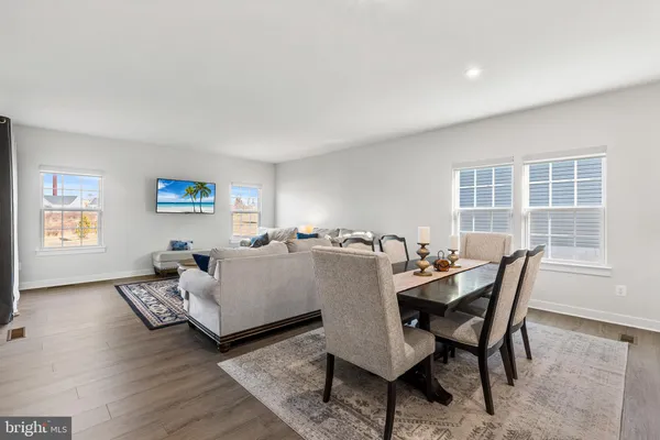 a large kitchen with a large counter top a sink stainless steel appliances and cabinets