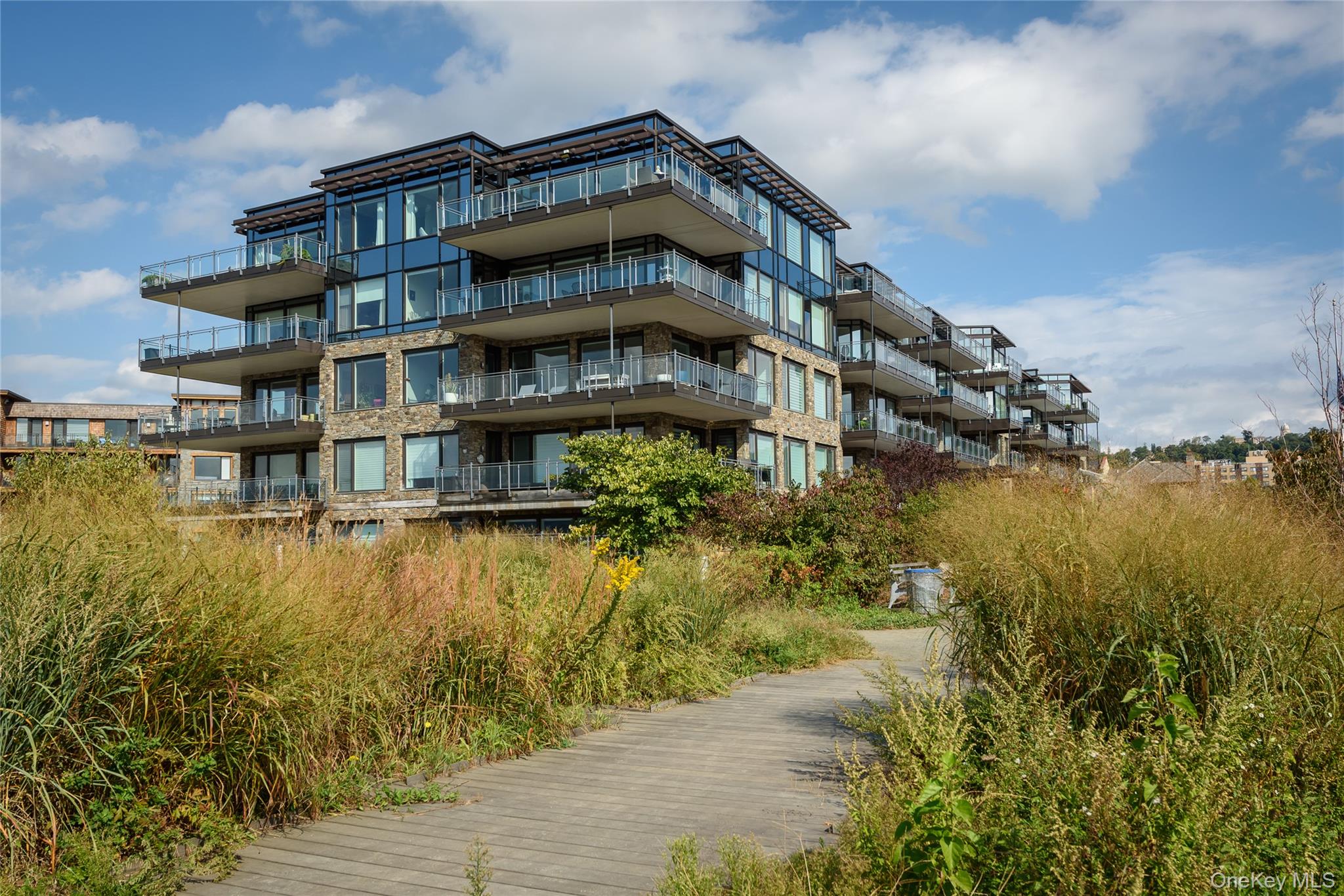 18 Rivers Edge Drive, Unit 211 Tarrytown, NY 10591 - Photo 28 of 30 a view of a large building with a lake