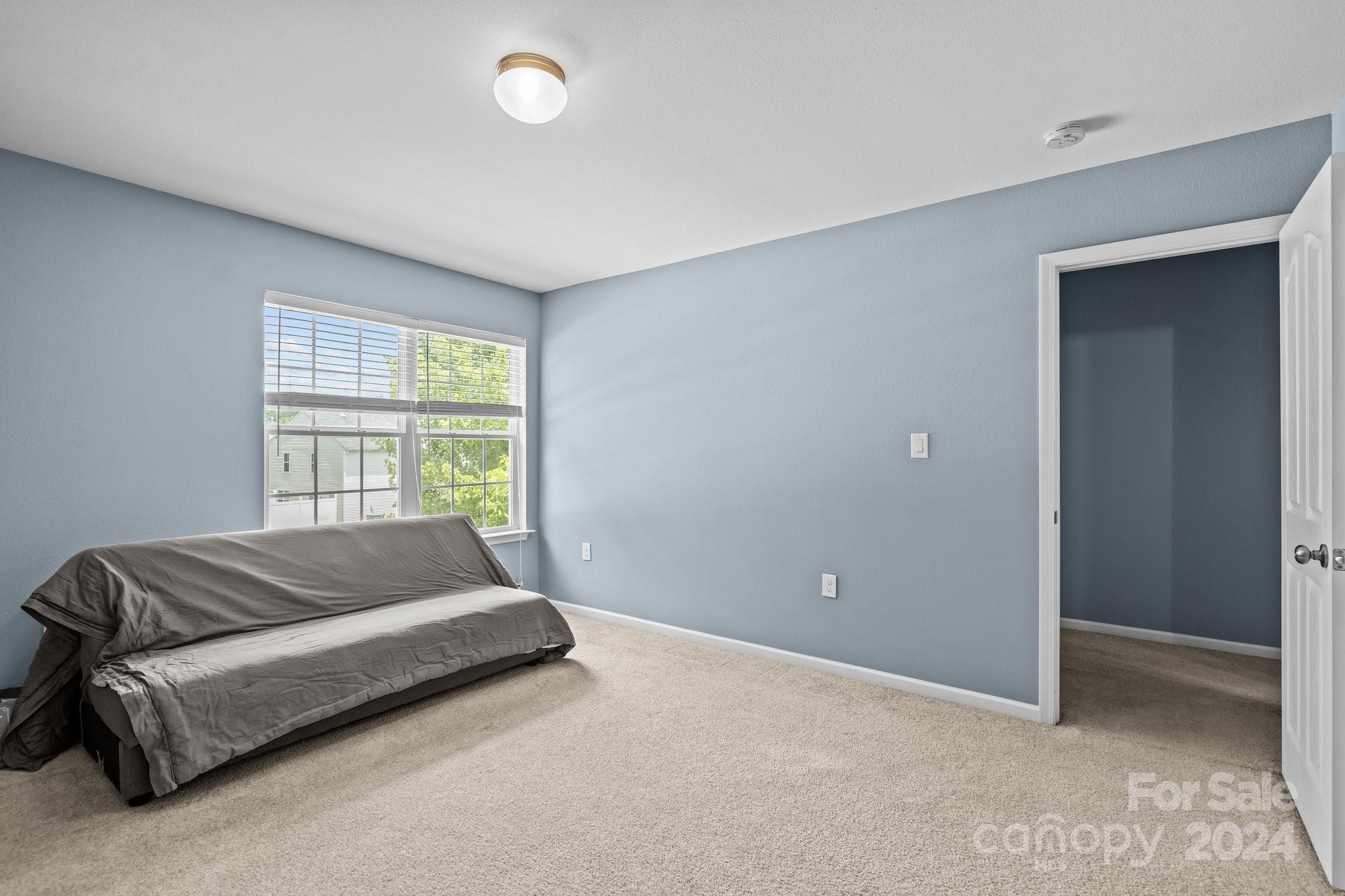 5511 Keener Ridge Road Charlotte, NC 28216 - Photo 11 of 31 a spacious bedroom with a bed and a window