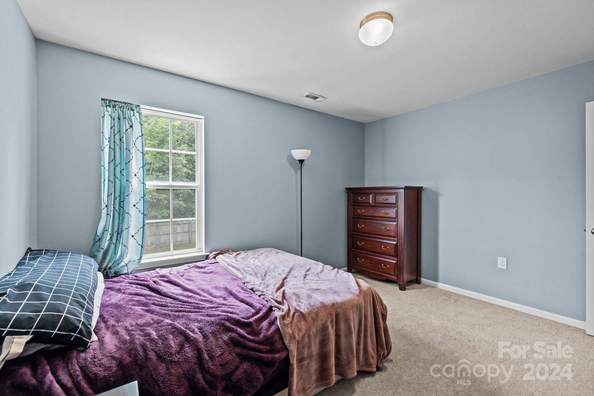 5511 Keener Ridge Road Charlotte, NC 28216 - Photo 13 of 31 a bedroom with a bed and a television